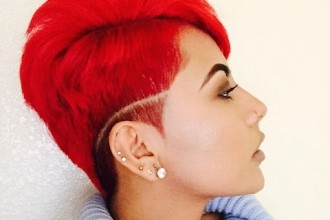 Tapered hair cut with red hair and defined part