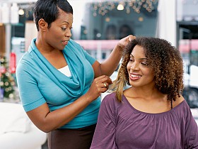 African American Hairstylist with her client