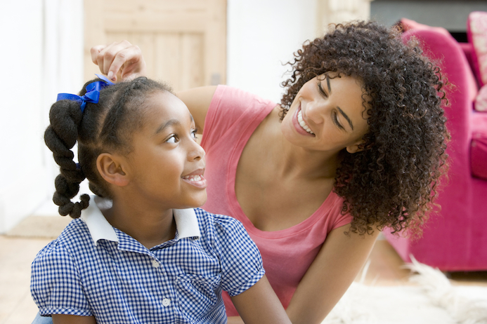 Mother Combing Daughter's Hair