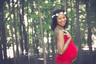 African American Pregnant woman smiling, VoiceOfHair Founder Brandy Green